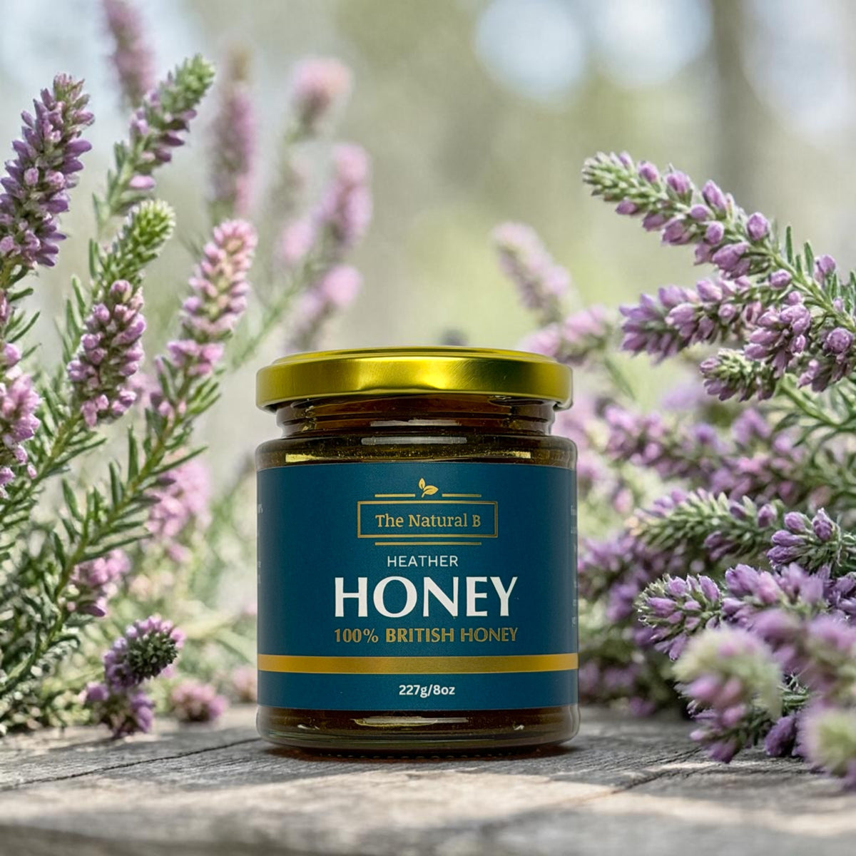 Jar of Heather Honey with a blue label surrounded by heather flowers.